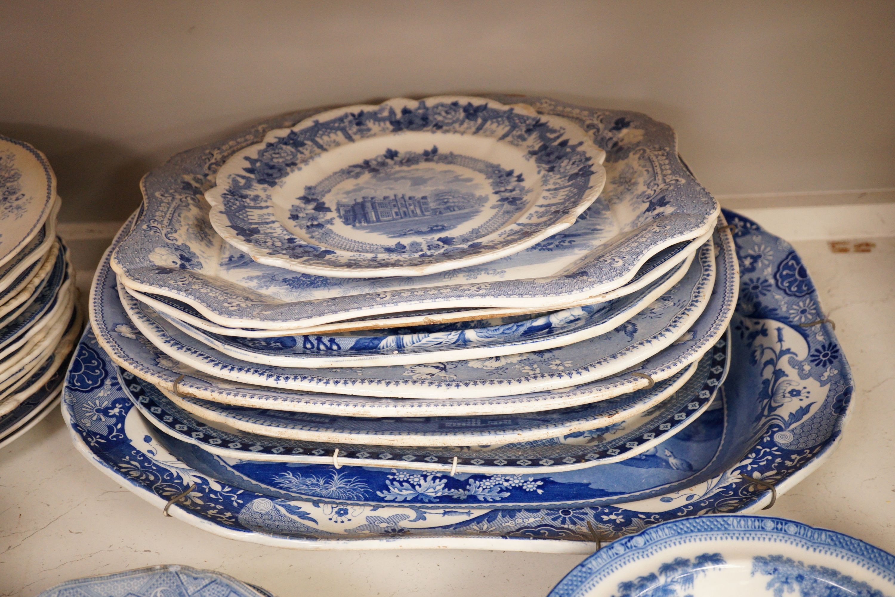 A collection of mostly 19th century blue and white transfer printed pottery tablewares